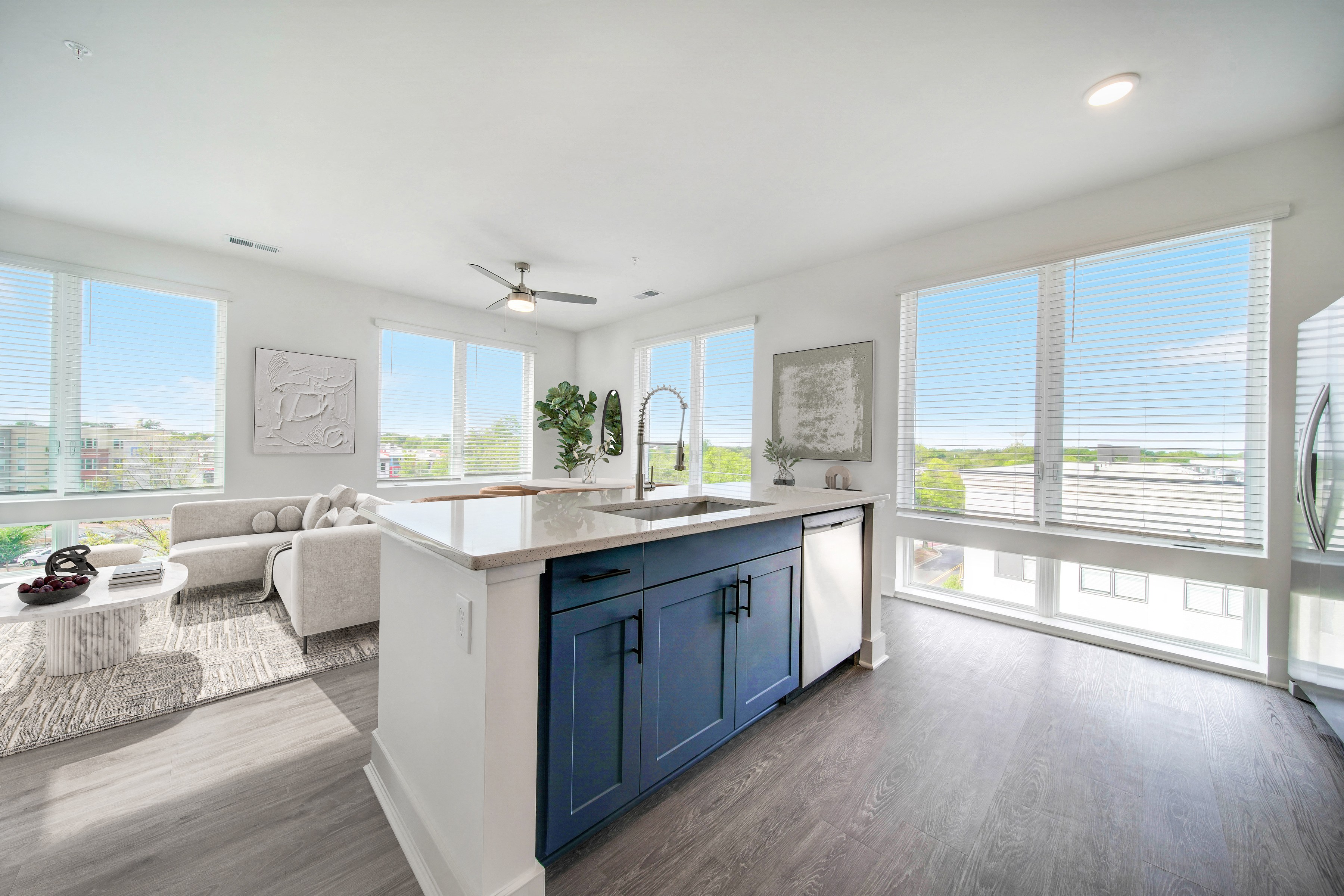 a kitchen with a blue island and a living room with a couch